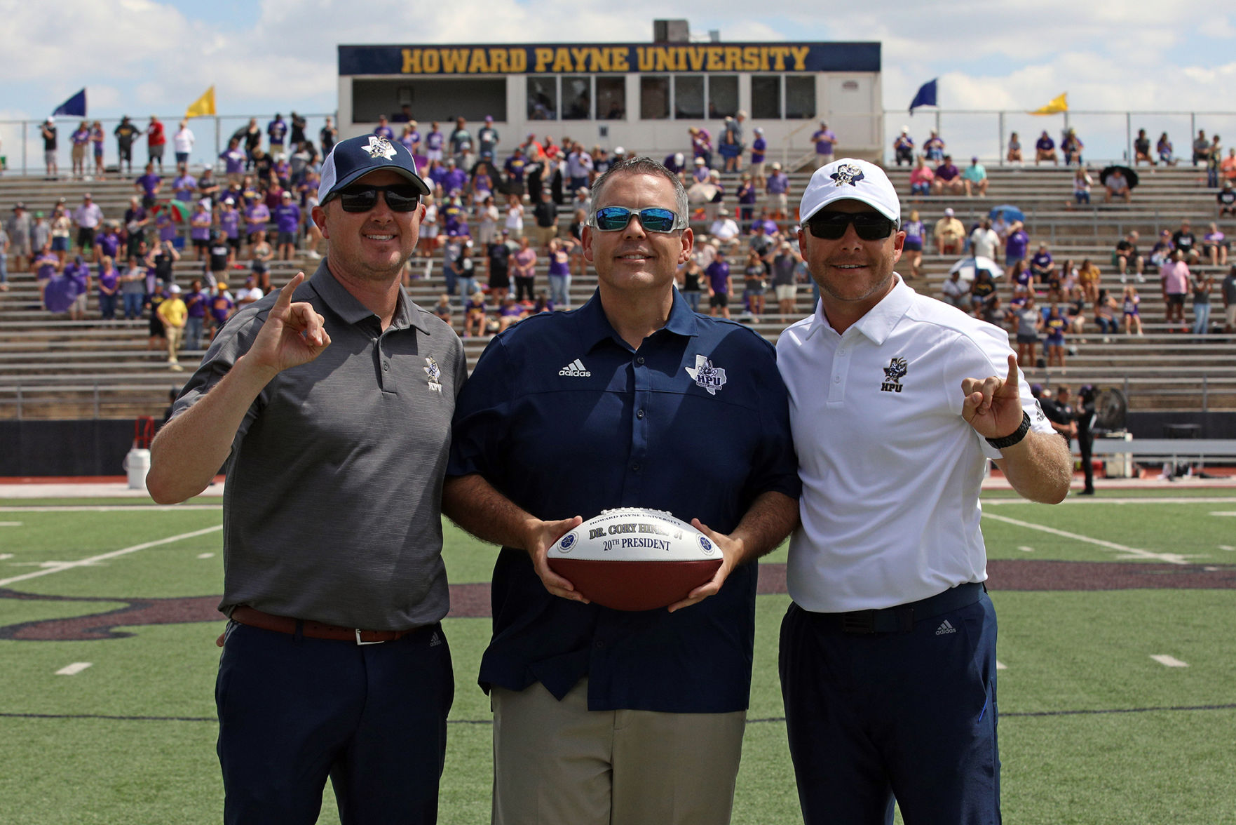 Sims, Dr. Hines and Harris with football.jpg